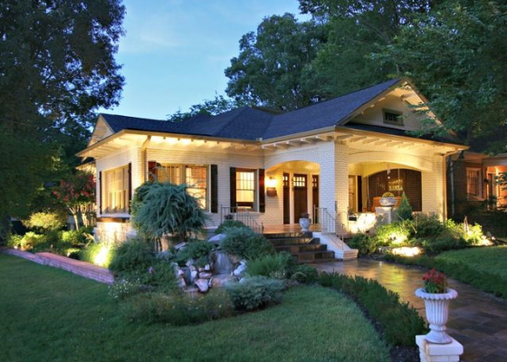 A well lit and beautifully landscaped home.